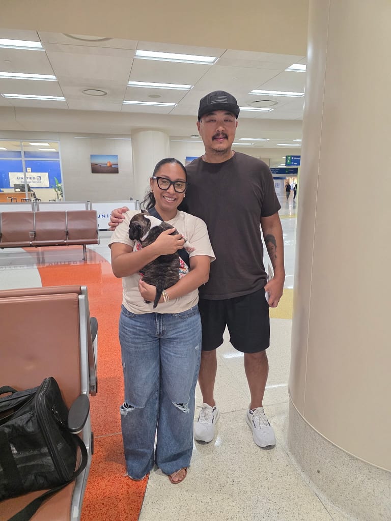 Geoffrey Malit and his family in San Antonio receiving their trained male black brindle micro bully puppy delivered by Southeast Bully Kennels nanny Veronica.