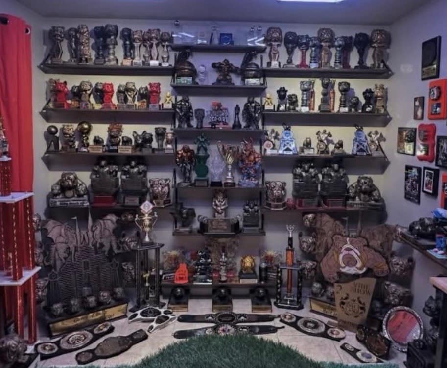 Room filled wall-to-wall with micro and pocket American Bully trophies, championship belts, statues, plaques, and awards displayed on shelves at Southeast Bully Kennels.